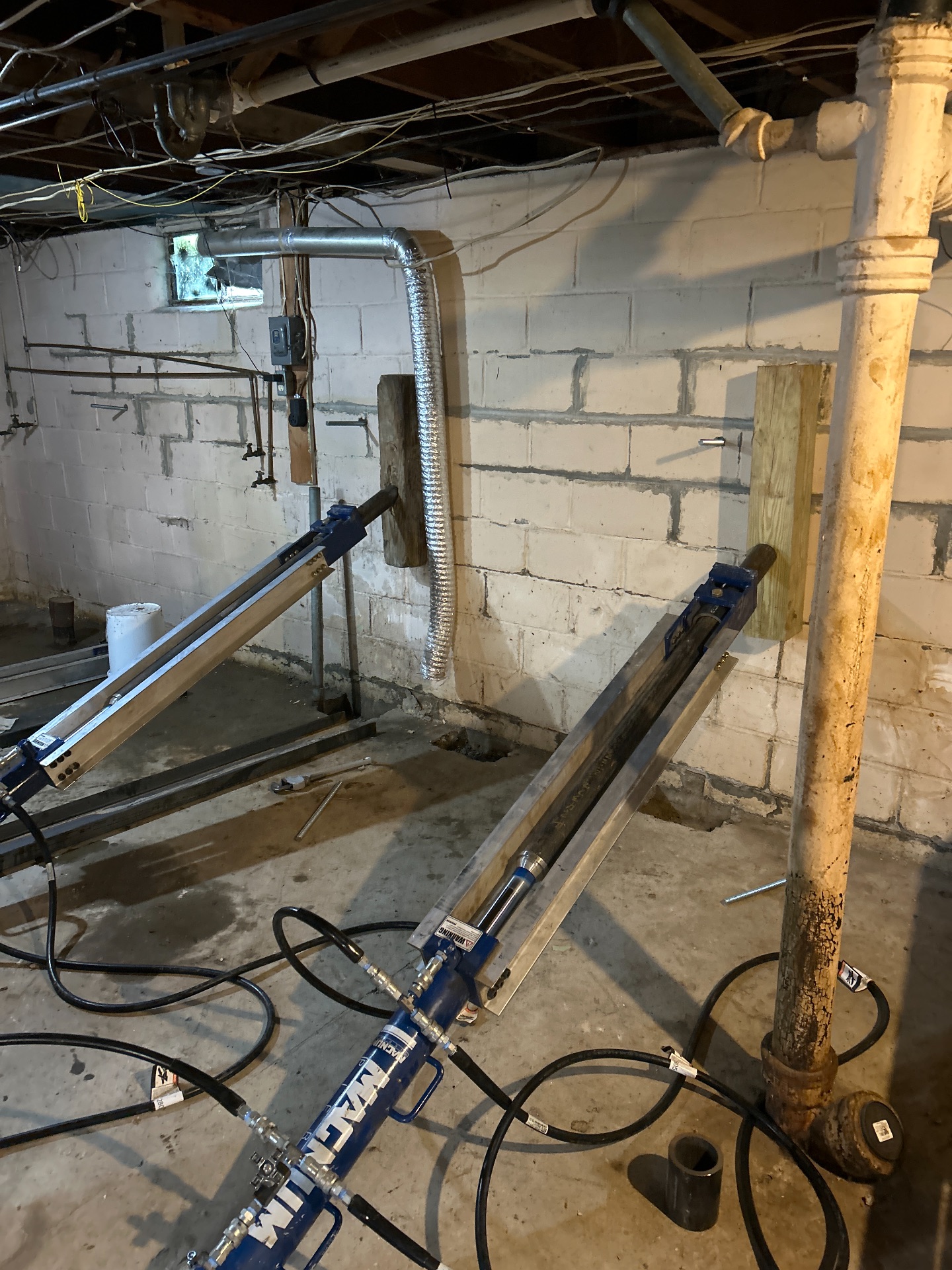 Steel wall anchor plate securing inward-pushing basement wall