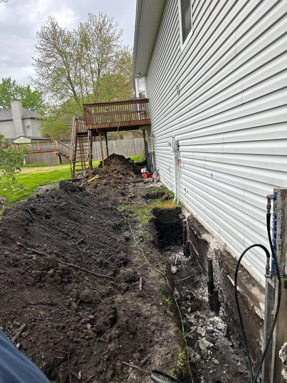 Steel push pier driven to bedrock for foundation stabilization